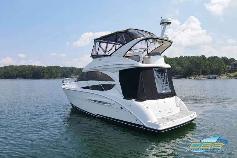 Slide: The Image of 2007 Meridian 341 Sedan yacht on serene lake with forested shoreline. - 7