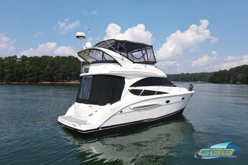 Slide: The Image of 2007 Meridian 341 Sedan yacht on a serene lake with forested shoreline. - 8