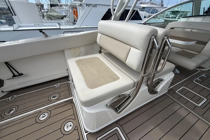 Slide: The Image of 2023 Boston Whaler 320 Vantage boat interior with cushioned seating and sleek design. - 12