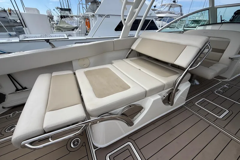 Slide: The Image of 2023 Boston Whaler 320 Vantage interior with adjustable seating and sleek design. - 13