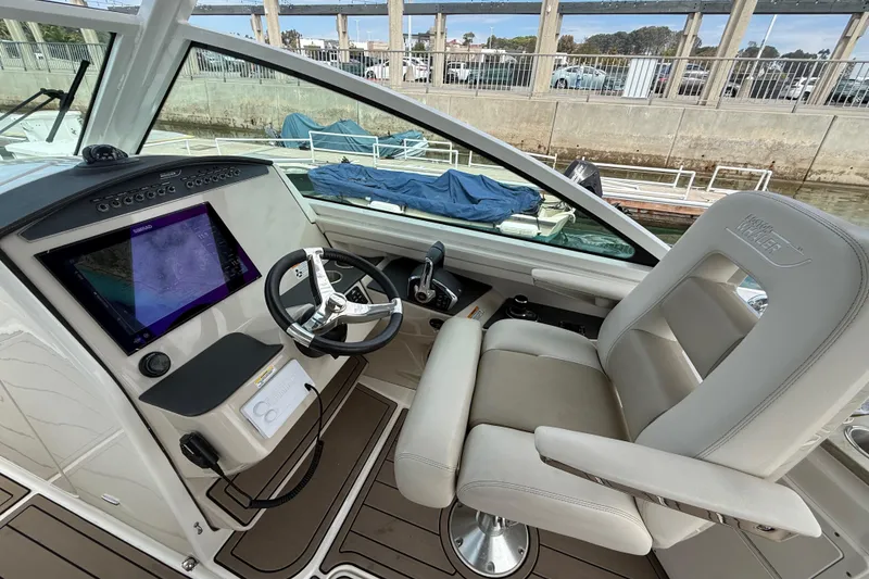 Slide: The Image of 2023 Boston Whaler 320 Vantage helm with modern controls and comfortable seating. - 16