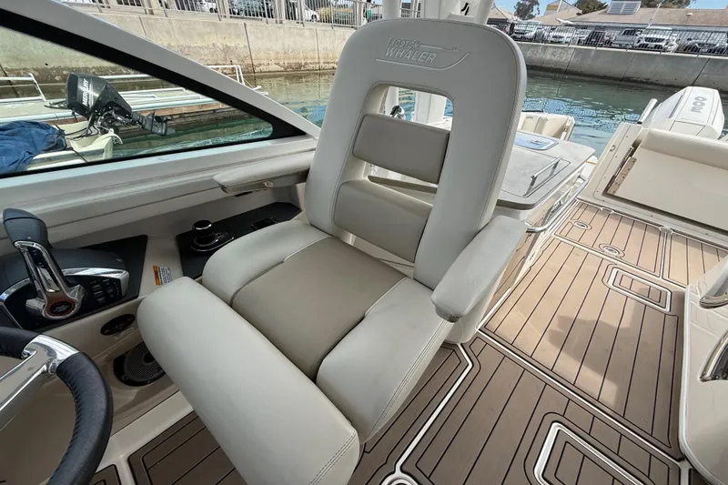 Slide: The Image of 2023 Boston Whaler 320 Vantage interior with luxurious seating and modern controls. - 18
