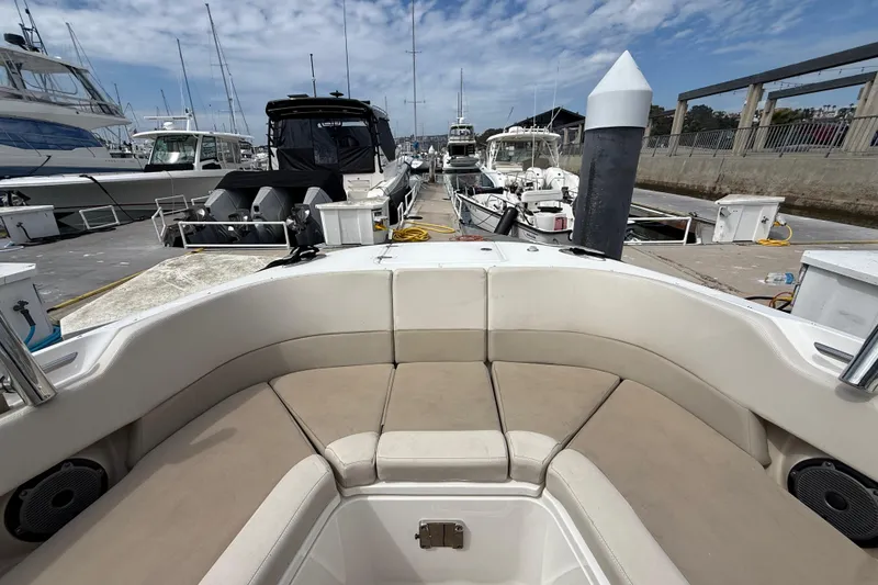Slide: The Image of 2023 Boston Whaler 320 Vantage docked at marina, showcasing spacious seating and sleek design. - 24