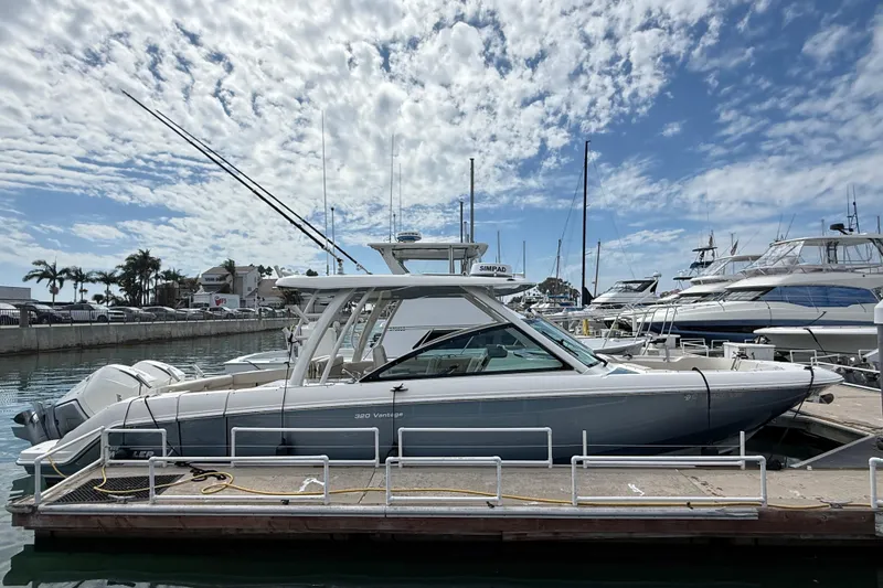 Slide: The Image of 2023 Boston Whaler 320 Vantage docked at marina under blue sky. - 5