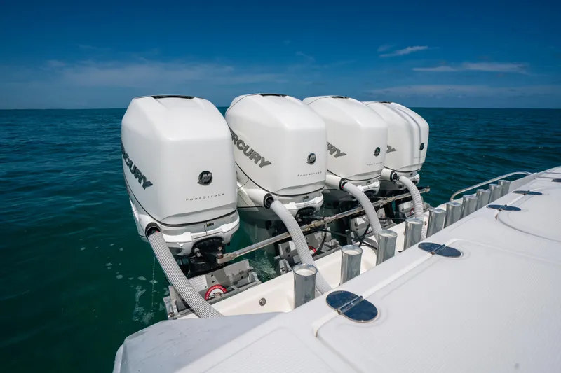 Slide: The Image of Four Mercury outboard engines on a 2006 Venture 39 Open boat in open water. - 19