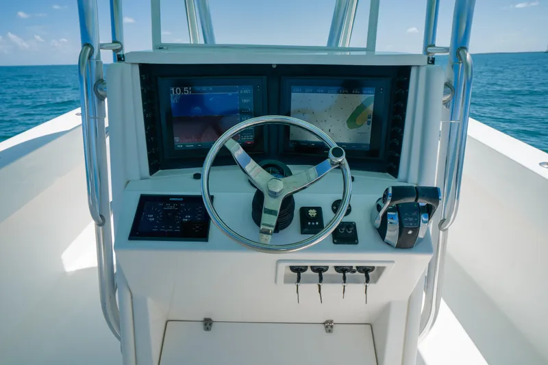 Slide: The Image of 2006 Venture 39 Open boat helm with navigation screens and steering wheel. - 22