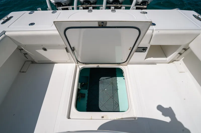 Slide: The Image of 2006 Venture 39 Open boat deck with open hatch, revealing storage compartment. - 30