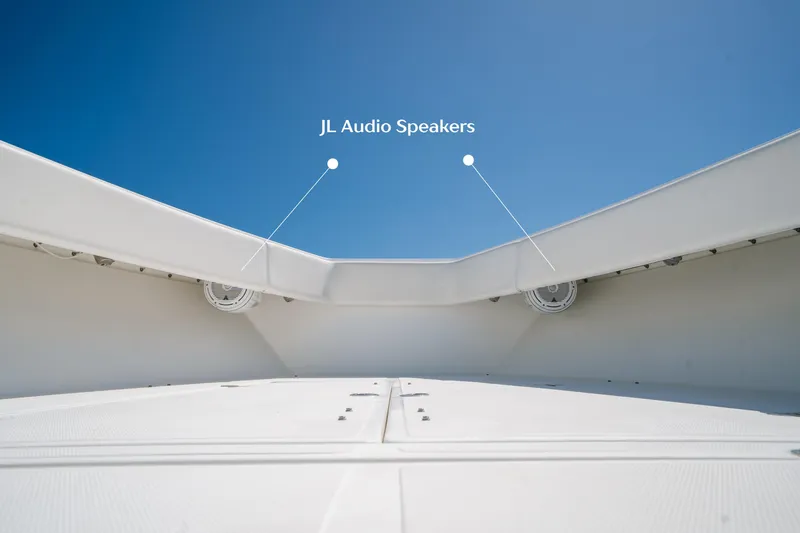 Slide: The Image of 2006 Venture 39 Open boat with JL Audio speakers under clear blue sky. - 37