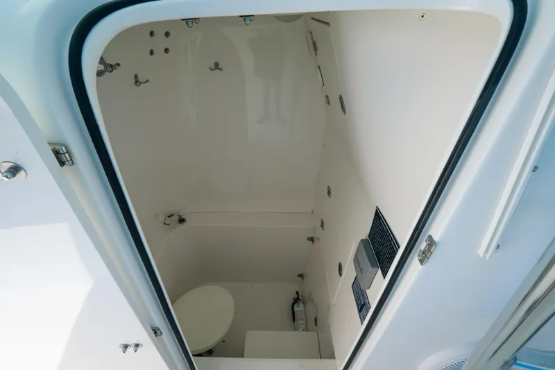 Slide: The Image of 2006 Venture 39 Open boat interior cabin with toilet and safety equipment. - 39