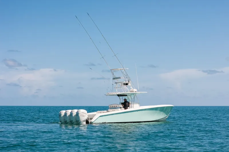 Slide: The Image of 2006 Venture 39 Open boat with multiple outboard engines on calm ocean. - 40