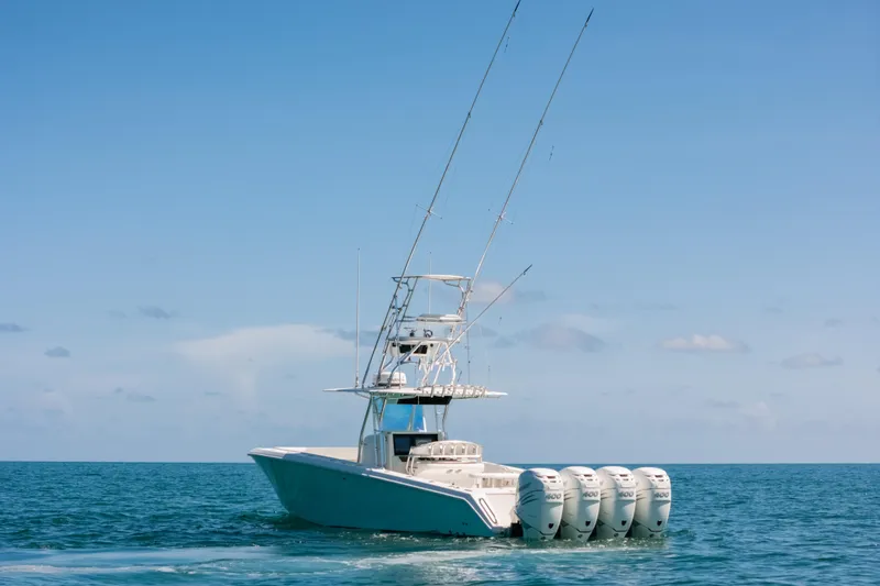 Slide: The Image of 2006 Venture 39 Open boat with four engines on open sea under clear sky. - 42