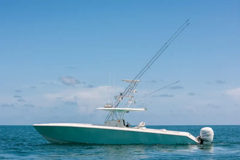 Slide: The Image of 2006 Venture 39 Open boat on calm ocean under clear blue sky. - 43