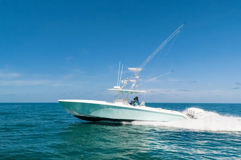 Slide: The Image of 2006 Venture 39 Open boat cruising on open sea under clear blue sky. - 45
