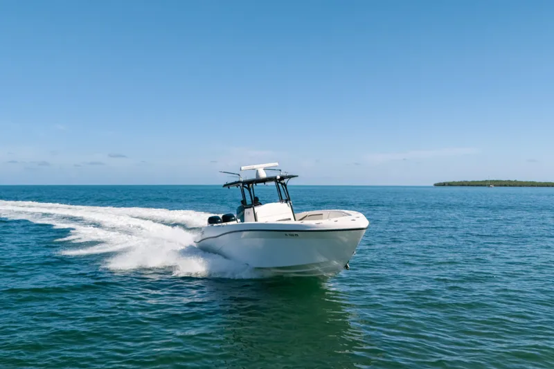 Slide: The Image of 2013 Deep Impact 33 boat cruising on open blue water under clear sky. - 1