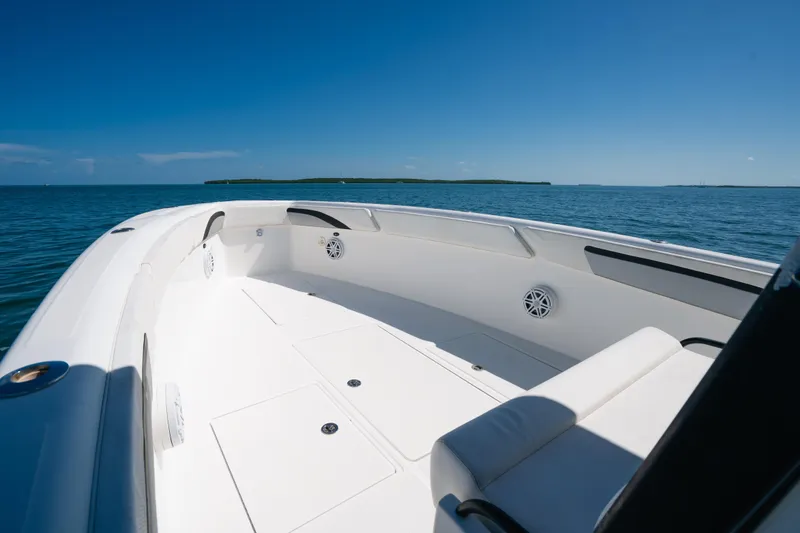 Slide: The Image of 2013 Deep Impact 33 boat on calm ocean, clear blue sky, spacious deck. - 11