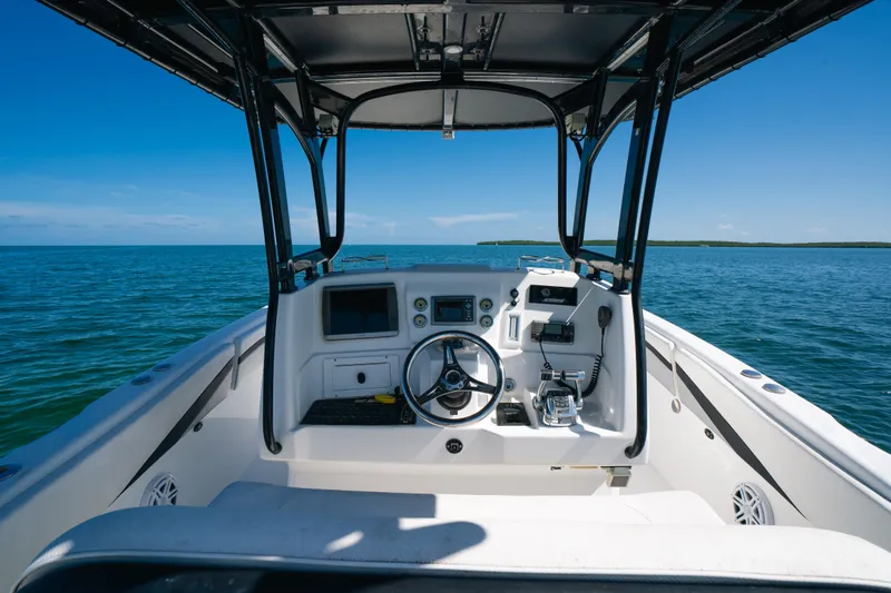 Slide: The Image of Cockpit view of 2013 Deep Impact 33 boat on open water under clear blue sky. - 17