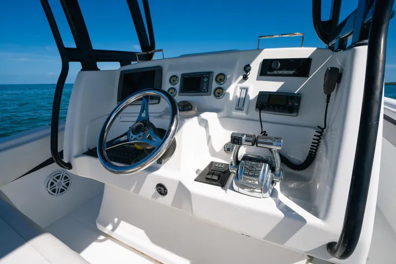 Slide: The Image of Cockpit of 2013 Deep Impact 33 boat with steering wheel and control panel. - 19