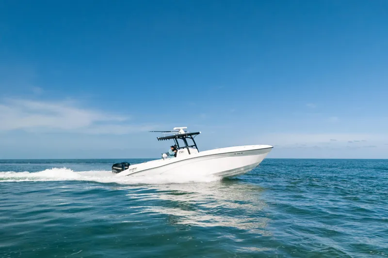 Slide: The Image of 2013 Deep Impact 33 boat cruising on open sea under clear blue sky. - 2