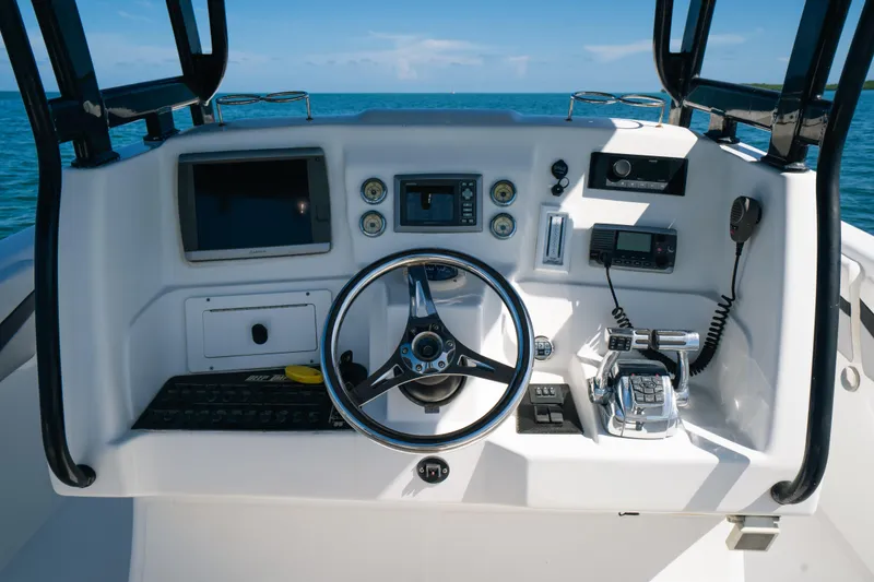Slide: The Image of Control panel of a 2013 Deep Impact 33 boat with steering wheel and navigation equipment. - 20