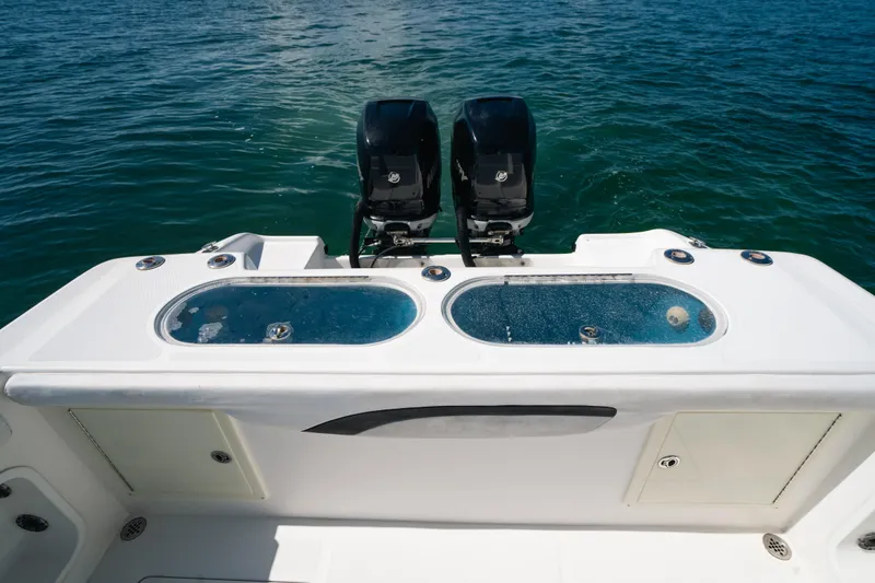 Slide: The Image of 2013 Deep Impact 33 boat with dual engines and live wells on open water. - 23