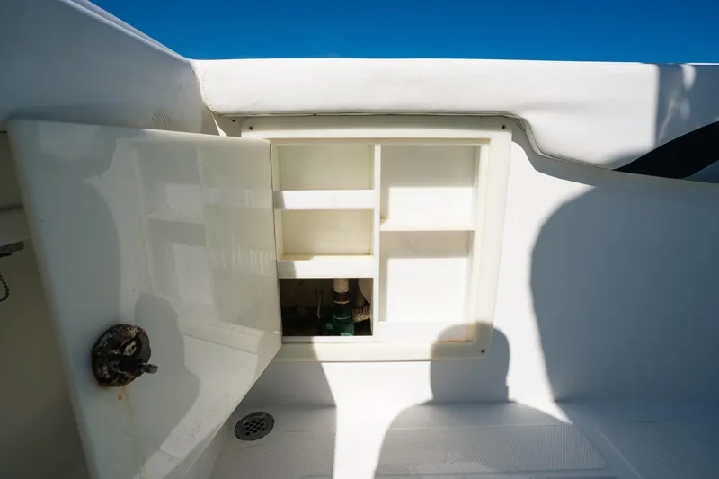 Slide: The Image of Open storage compartment on 2013 Deep Impact 33 boat, showcasing interior shelving. - 29