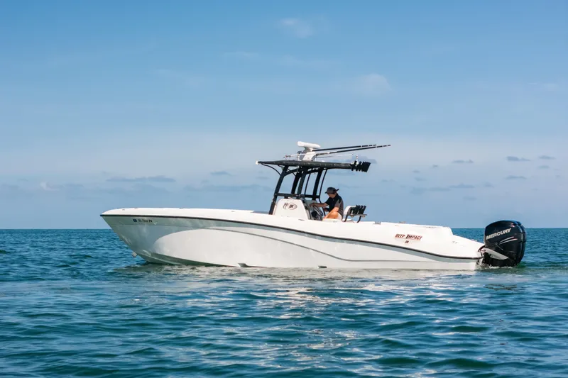 Slide: The Image of 2013 Deep Impact 33 boat cruising on open water under clear blue skies. - 30