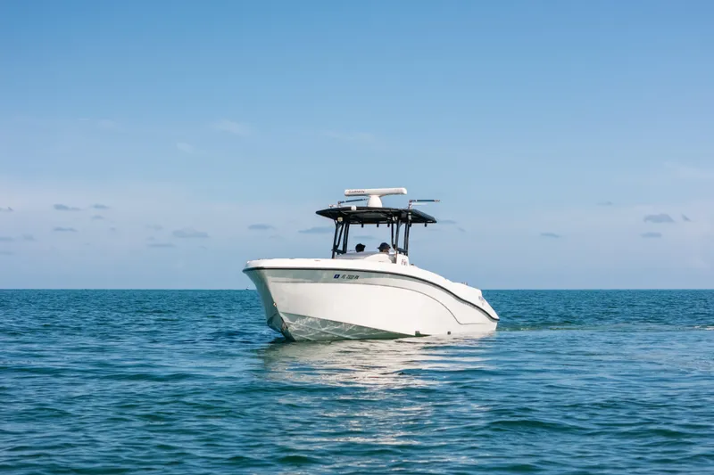 Slide: The Image of 2013 Deep Impact 33 boat cruising on calm ocean waters under clear blue sky. - 31