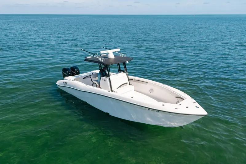 Slide: The Image of 2013 Deep Impact 33 boat on calm ocean waters, featuring dual engines and sleek design. - 4