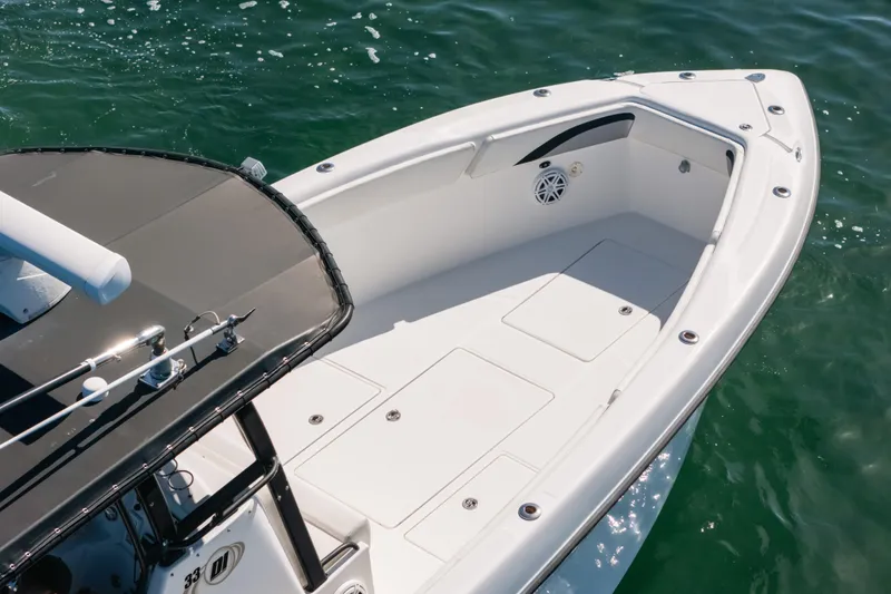 Slide: The Image of 2013 Deep Impact 33 boat, white deck, sleek design, on clear water. - 5