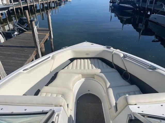 Slide: The Image of 2016 Cobalt R3 boat with white seating, docked at a calm marina. - 13