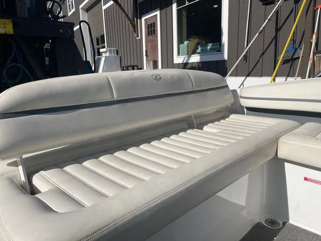 Slide: The Image of 2016 Cobalt R3 boat with white leather seating, docked near a building. - 14