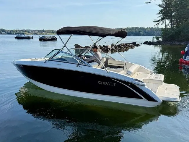 Slide: The Image of 2016 Cobalt R3 boat with canopy on calm lake near rocky shoreline. - 3