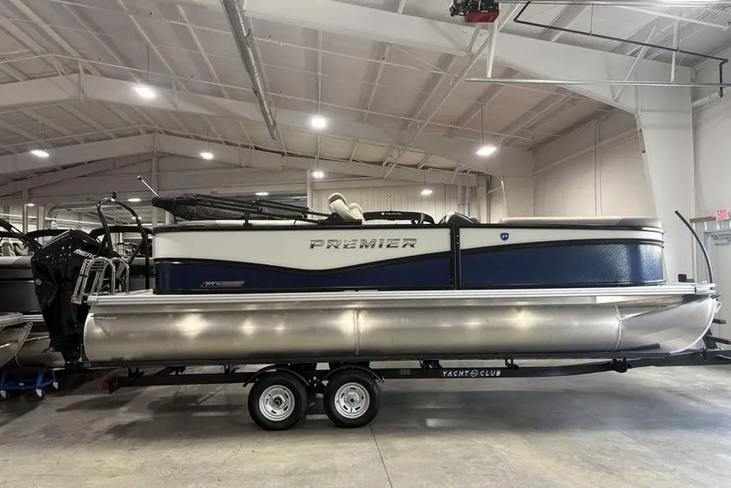 The Image of 2026 Premier 220 Sunscape RF pontoon boat in a showroom on a trailer. - 0