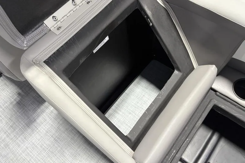 Slide: The Image of Open storage compartment in 2026 Premier 220 Sunscape RF boat, featuring sleek upholstery. - 21