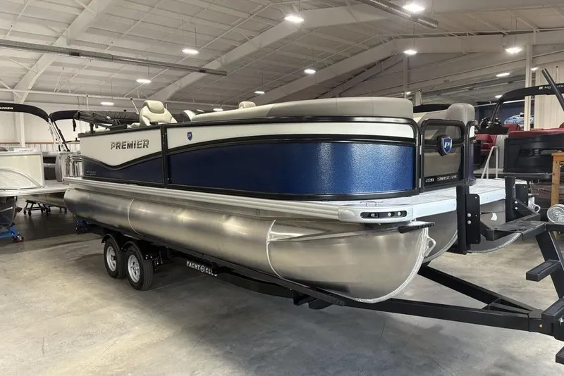 Slide: The Image of 2026 Premier 220 Sunscape RF pontoon boat on trailer in indoor showroom. - 3