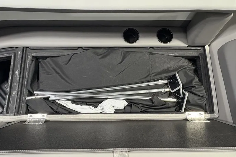Slide: The Image of Storage compartment in 2026 Premier 220 Sunscape RF boat with metal poles and fabric. - 5