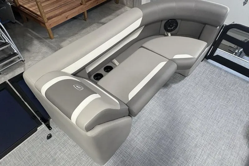 Slide: The Image of 2026 Premier 220 Sunscape RF boat interior with gray and white seating, cup holders, and speaker. - 6
