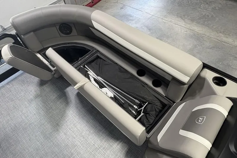 Slide: The Image of 2026 Premier 220 Sunscape RF boat interior with storage compartment and cup holders. - 9