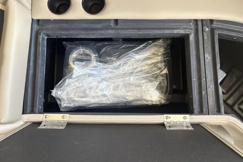 Slide: The Image of Storage compartment in 2026 Premier 220 Sunscape RF boat, featuring wrapped accessories. - 10