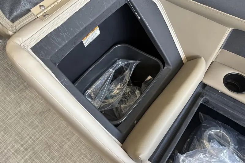 Slide: The Image of Storage compartment in 2026 Premier 220 Sunscape RF boat with beige upholstery. - 12
