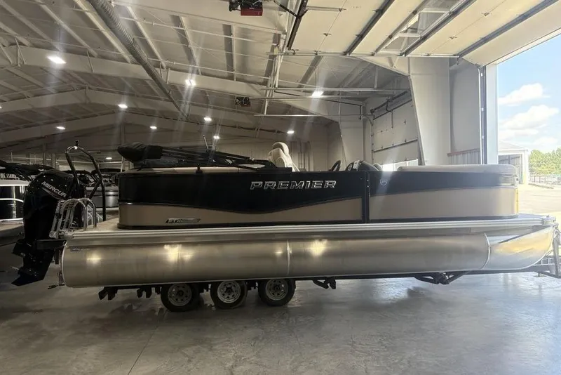The Image of 2026 Premier 220 Sunscape RF pontoon boat in a spacious indoor showroom. - 2