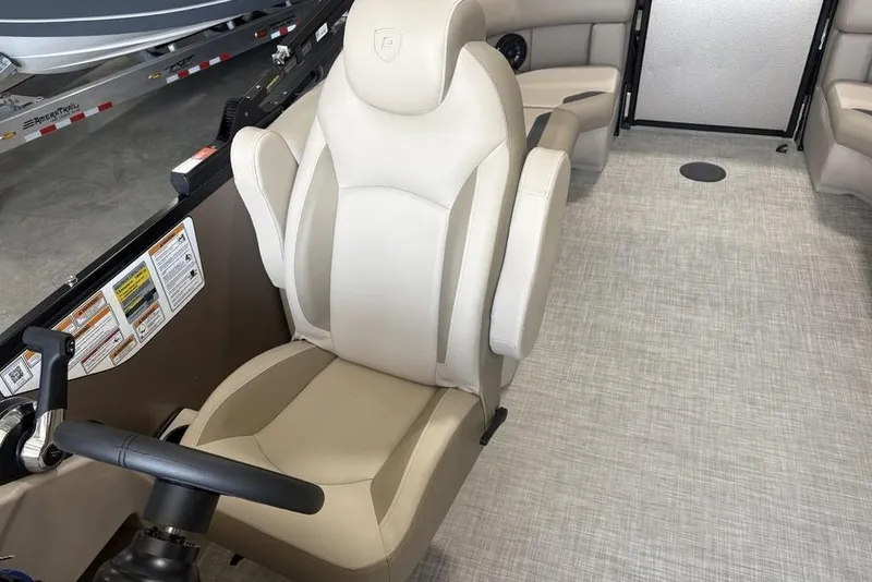 Slide: The Image of 2026 Premier 220 Sunscape RF boat interior with beige captain's chair and steering wheel. - 20