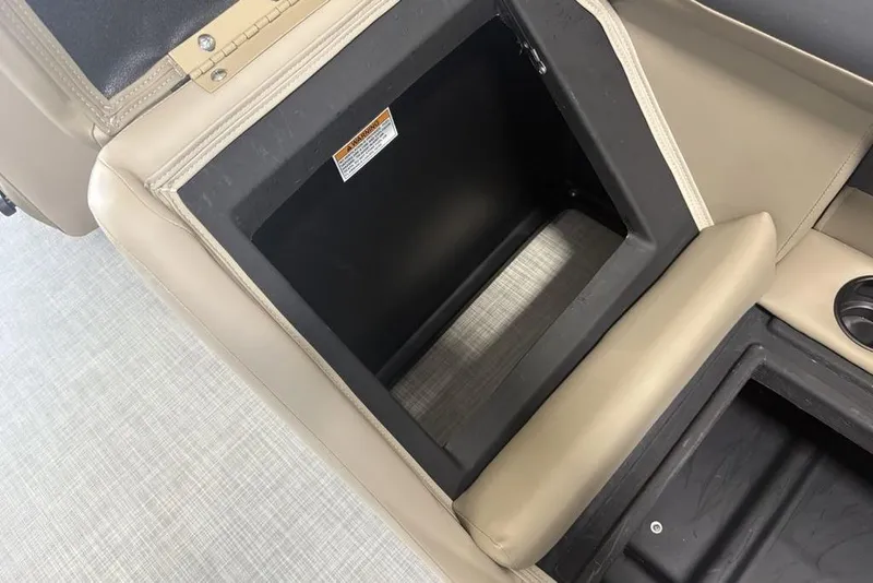 Slide: The Image of Open storage compartment in 2026 Premier 220 Sunscape RF boat with beige seating. - 29