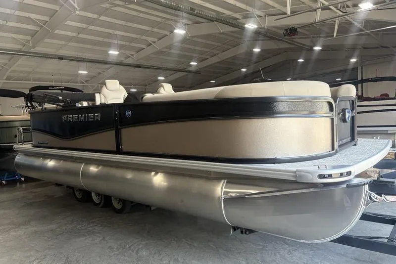 Slide: The Image of 2026 Premier 220 Sunscape RF pontoon boat in a spacious indoor showroom. - 3