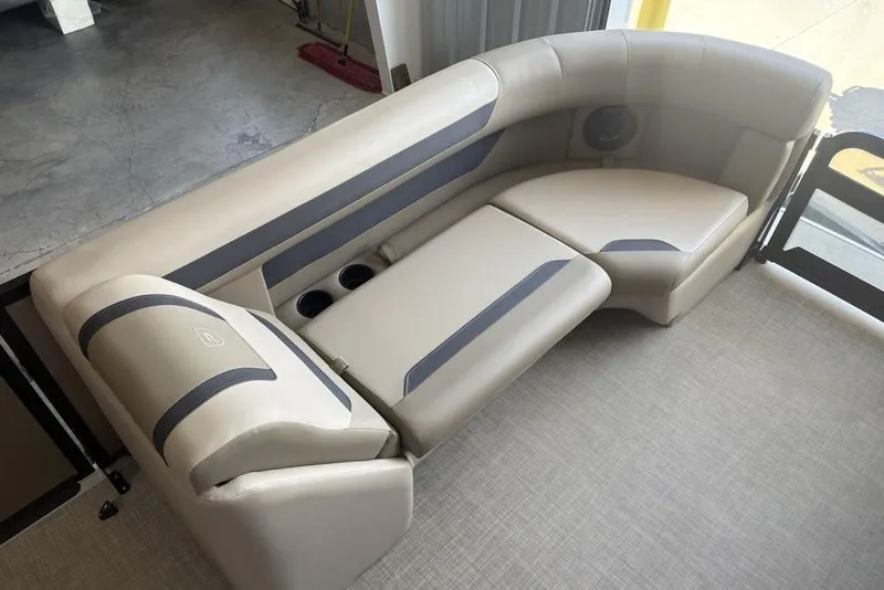 Slide: The Image of Luxurious seating on 2026 Premier 220 Sunscape RF boat, featuring beige upholstery and cup holders. - 4