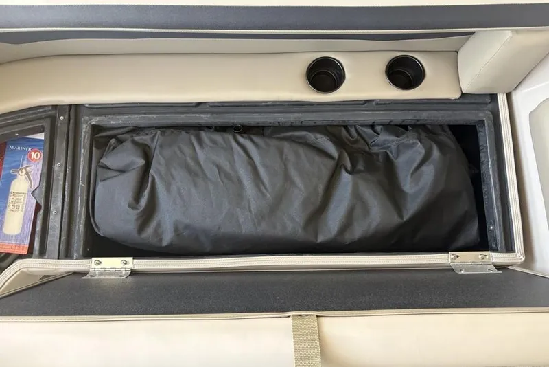 Slide: The Image of Storage compartment in 2026 Premier 220 Sunscape RF boat with fire extinguisher and bag. - 6