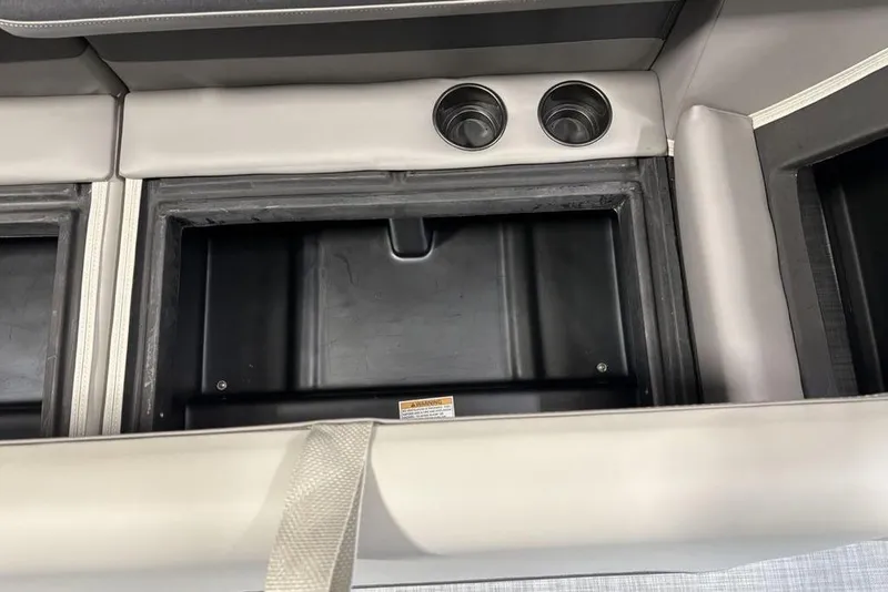 Slide: The Image of Interior storage compartment with cup holders in 2026 Premier 220 Sunscape RF XLC boat. - 16