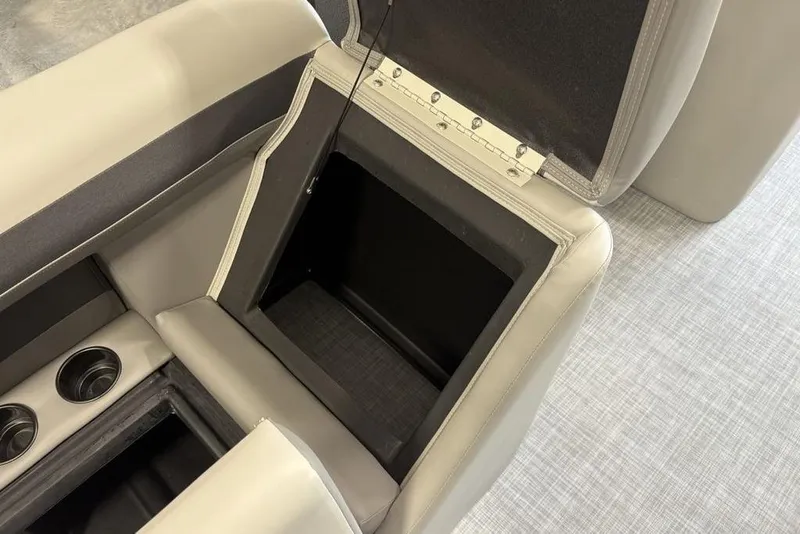 Slide: The Image of Open storage compartment in 2026 Premier 220 Sunscape RF XLC boat with cup holders. - 21