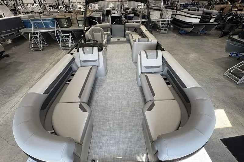 Slide: The Image of 2026 Premier 220 Sunscape RF XLC pontoon boat with spacious seating in showroom. - 27
