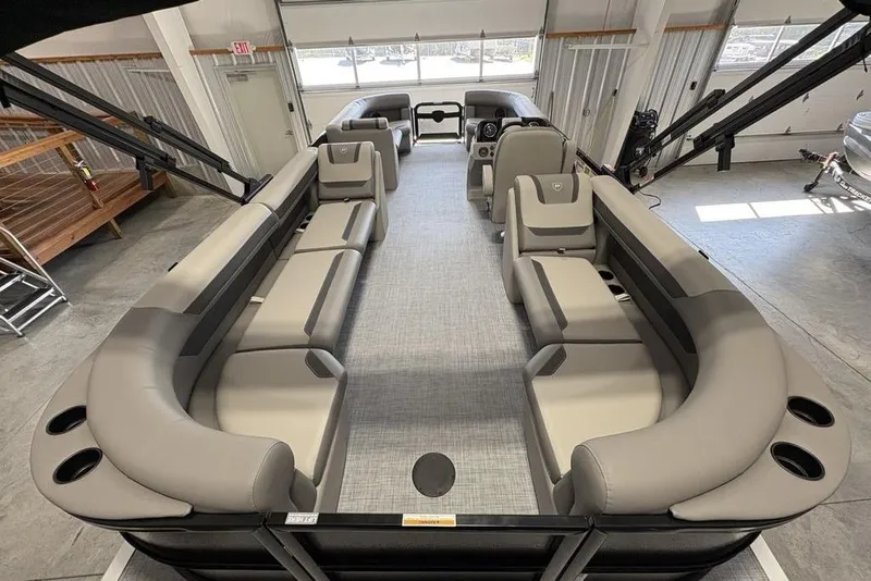Slide: The Image of 2026 Premier 220 Sunscape RF XLC pontoon boat with spacious seating in a showroom. - 28